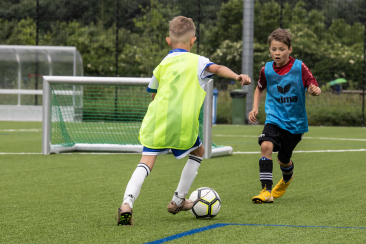 Fussball spielende Kinder Kunstrasenplatz Obere Au Chur